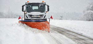Snow plow clearing a snowy road